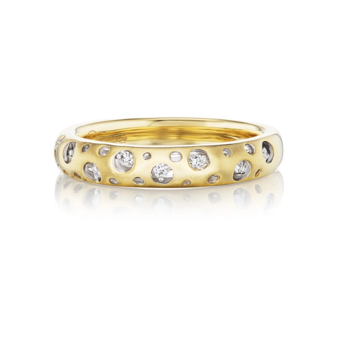 A gold ring with diamonds on it's side.