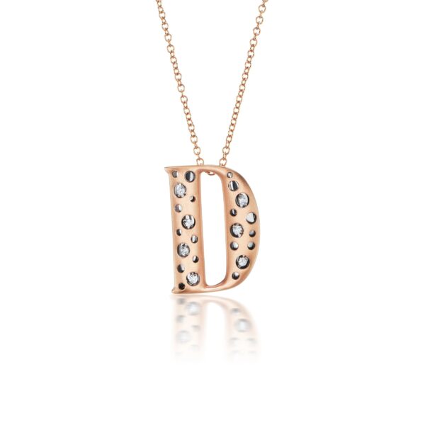 A rose gold necklace with the letter d
