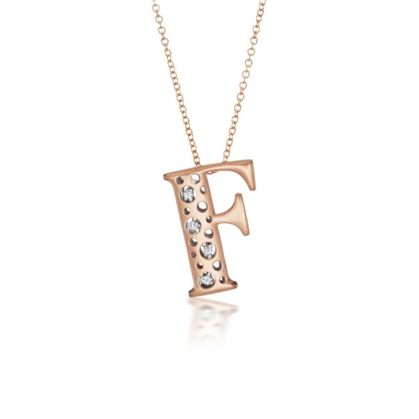 A rose gold necklace with the letter f