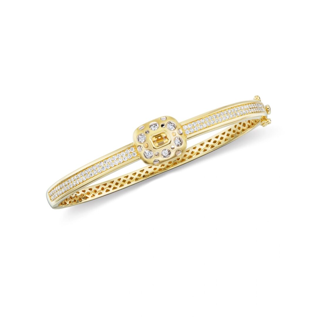 A gold bracelet with a diamond on it.