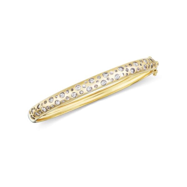 A gold and diamond bangle bracelet.