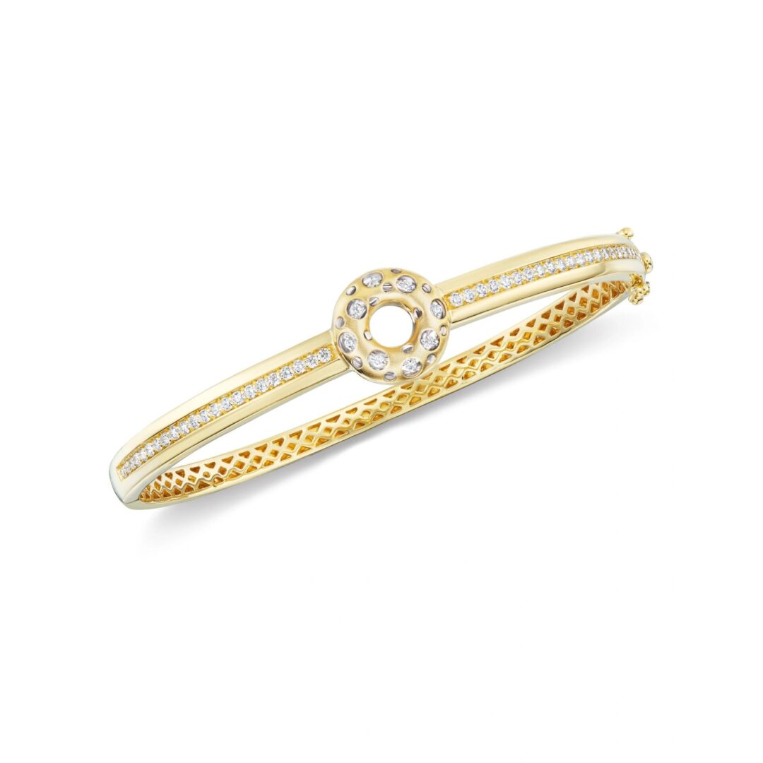 A gold bracelet with a diamond in the middle.