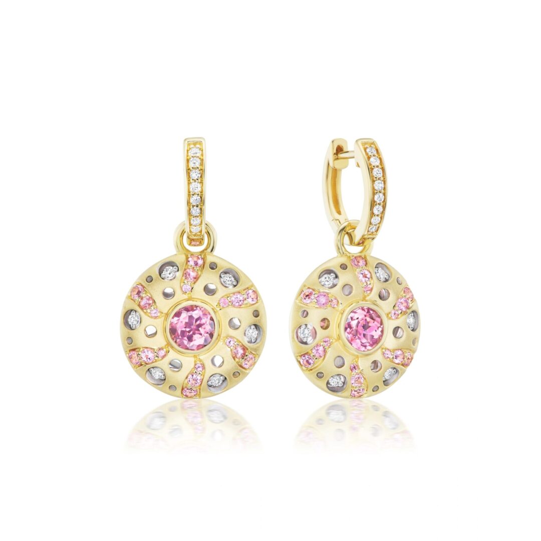 A pair of gold earrings with pink and white diamonds.