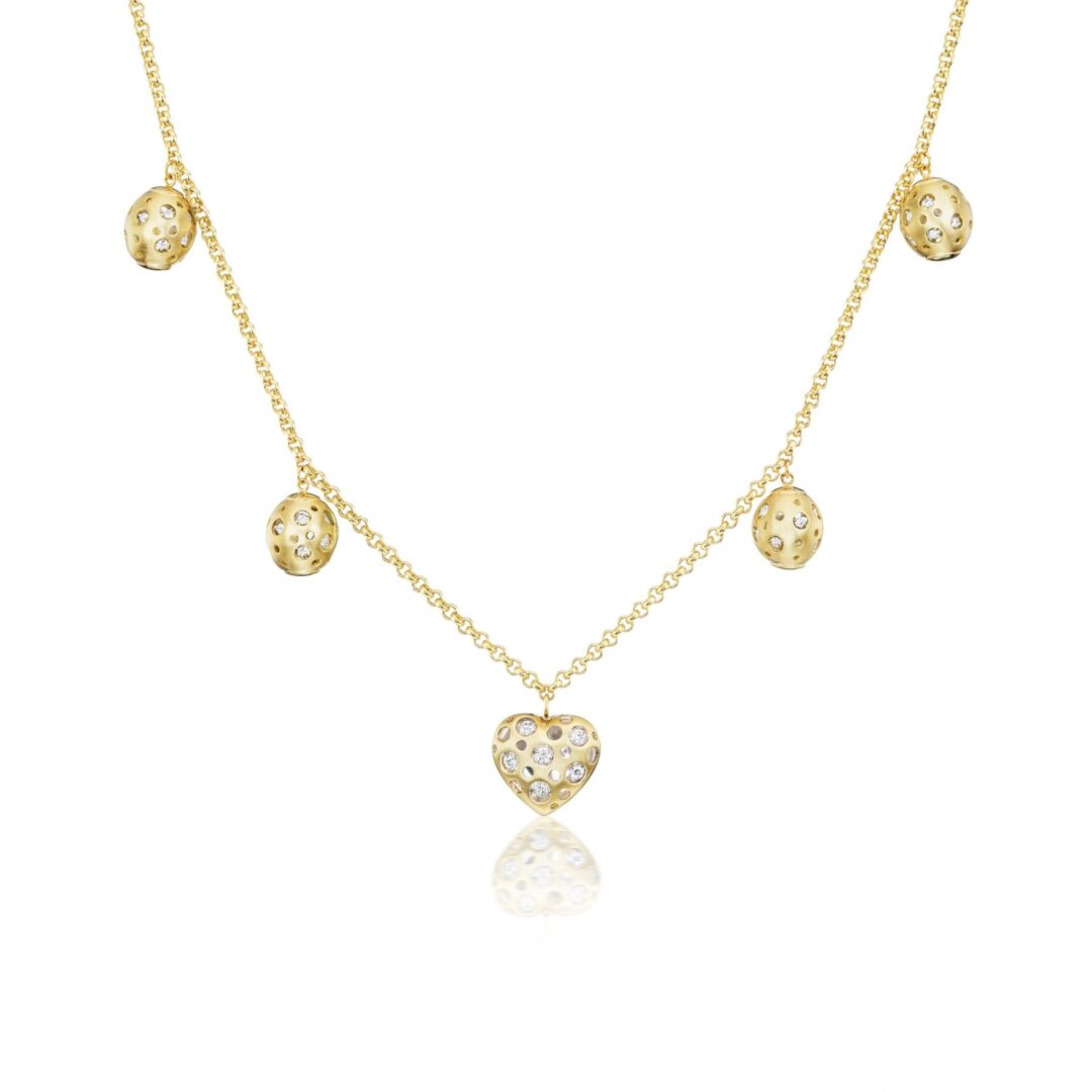 A gold necklace with five hearts hanging from it.