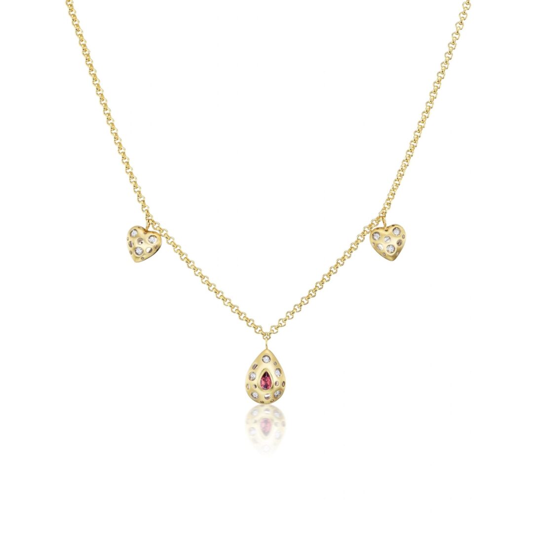 A gold necklace with three dangling hearts.