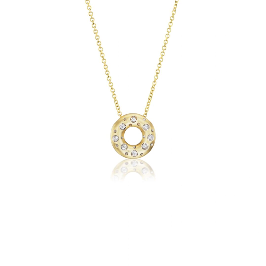 A gold necklace with a circle of diamonds on it.