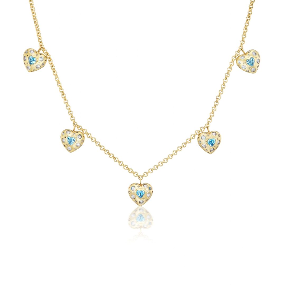 A gold necklace with five hearts and blue topaz.