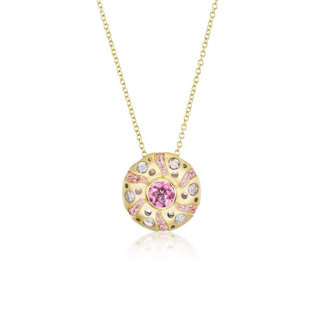 A gold necklace with pink and white diamonds.