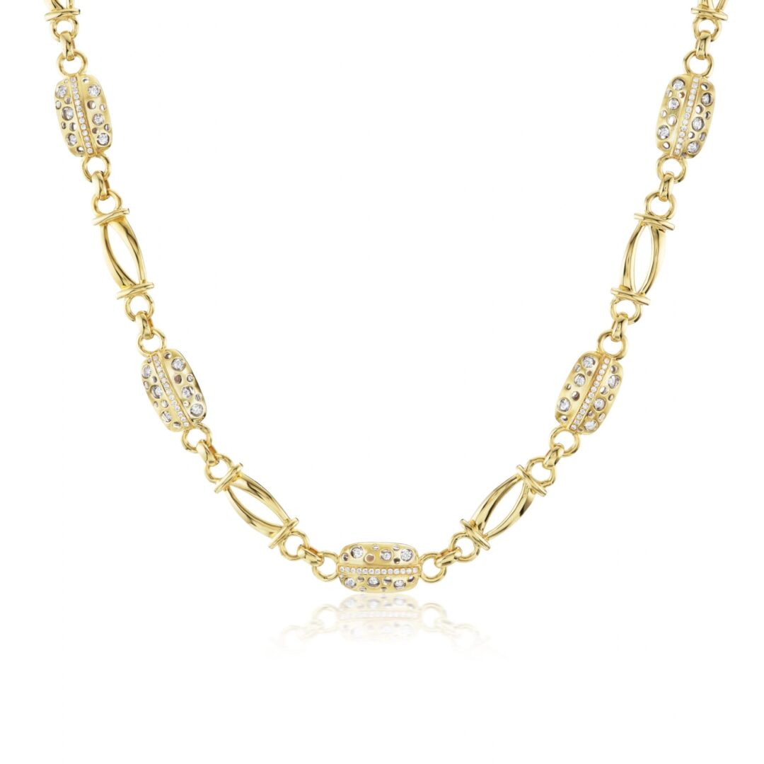 A gold chain with five small diamonds on it.