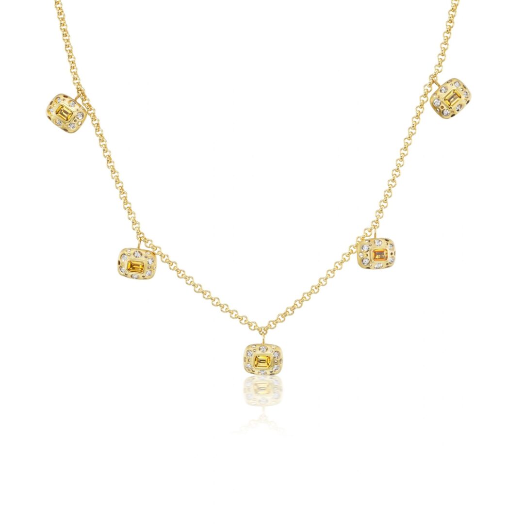 A gold necklace with five small squares on it.