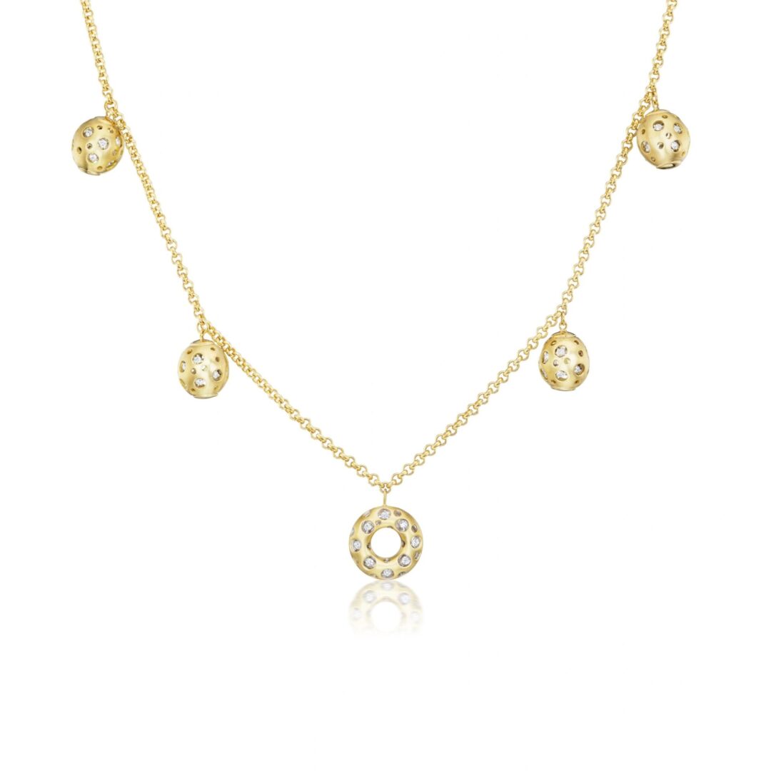 A gold necklace with five circles hanging from it.