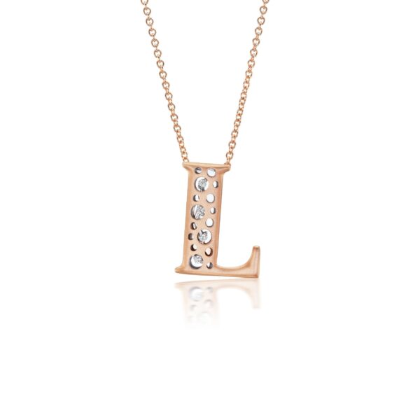 A rose gold initial necklace with diamonds.