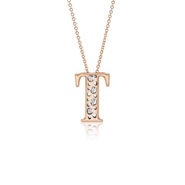 A rose gold initial necklace with diamonds.