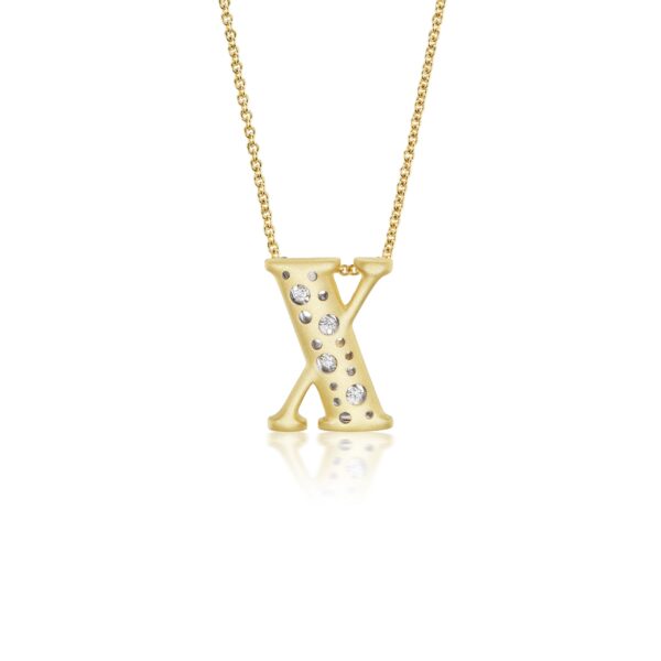 A gold necklace with the letter x