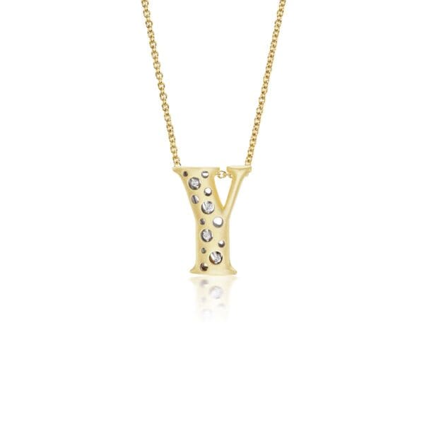 A gold necklace with the letter y