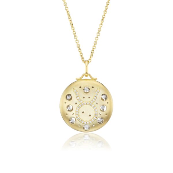 A gold necklace with a round pendant and some small diamonds