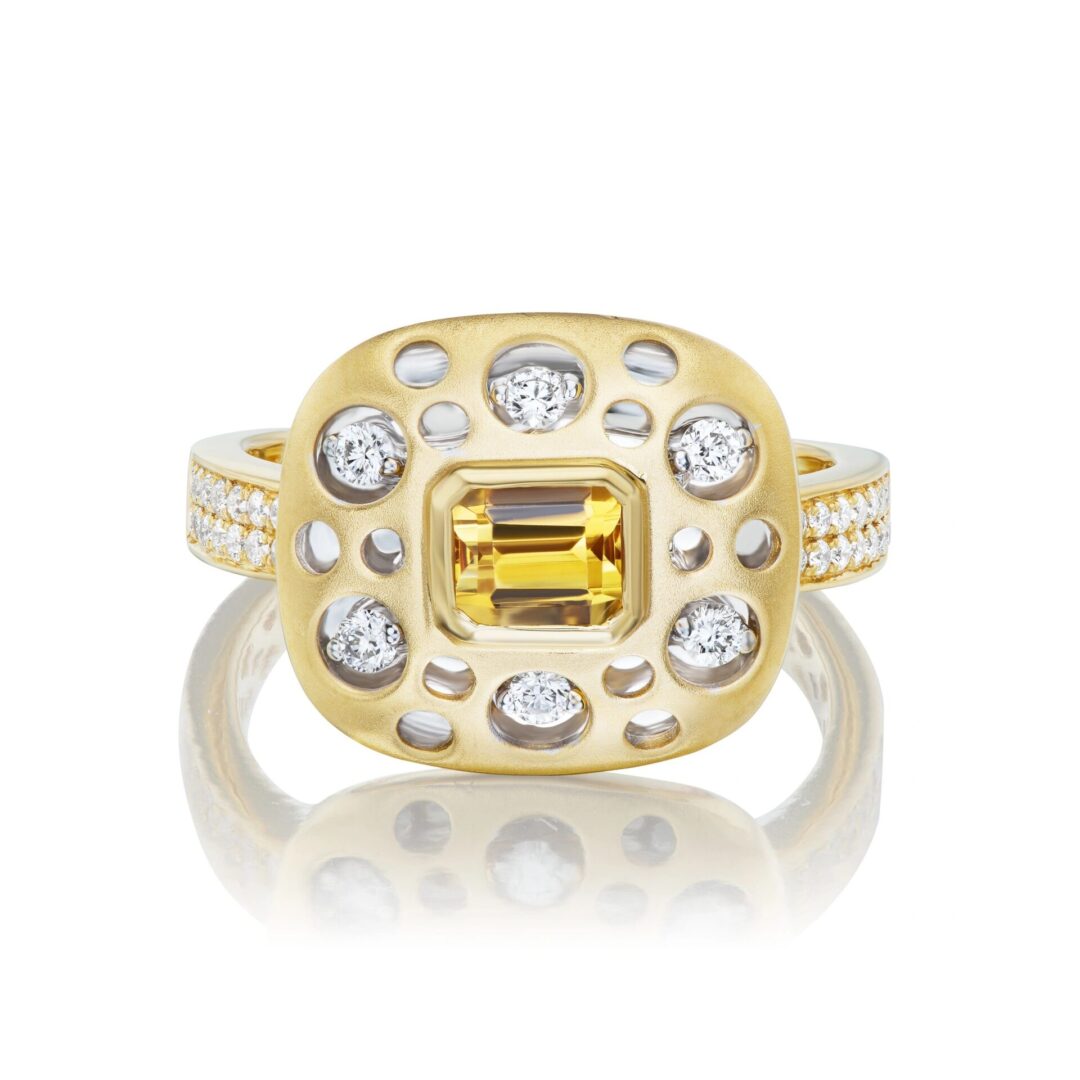 A yellow diamond ring with white diamonds in the center.