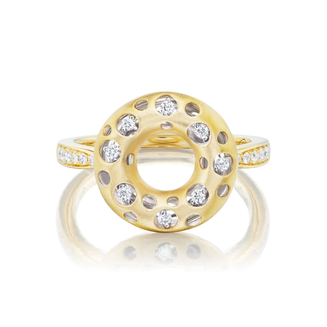 A yellow gold ring with diamonds on top of it.