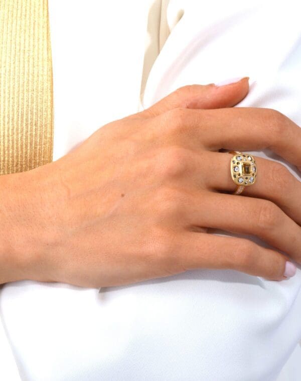 A woman wearing an engagement ring on her right hand.