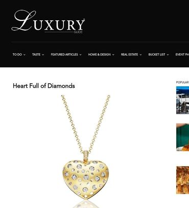 A gold heart shaped necklace with diamonds on it.