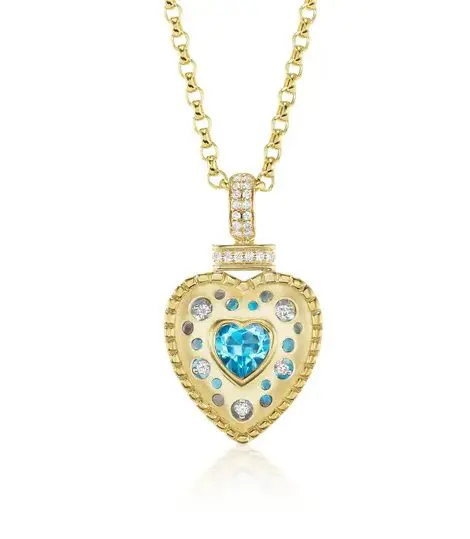 A gold necklace with a heart shaped blue stone.