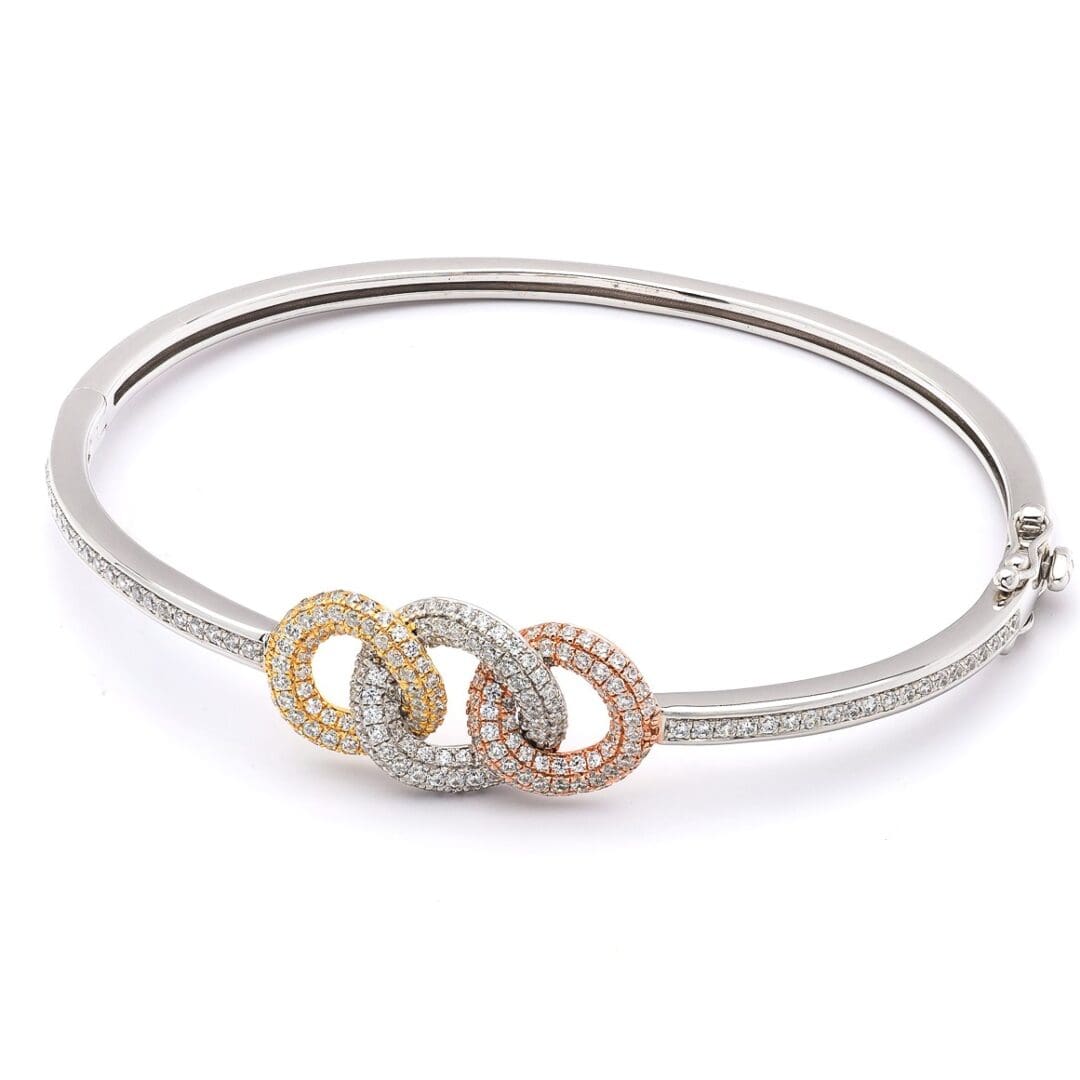 Diamond bangle with three linked rings.