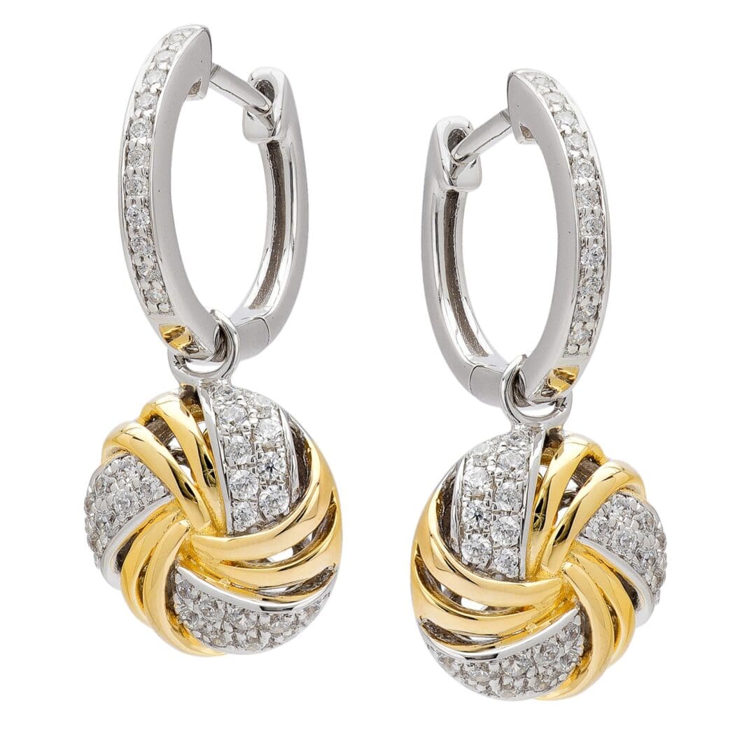 Diamond hoop earrings with gold accents.
