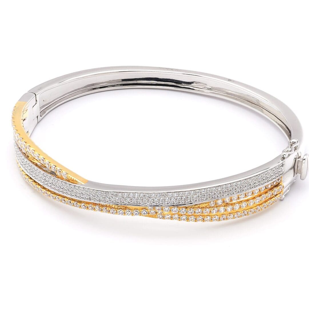 Diamond bangle bracelet with gold accents.
